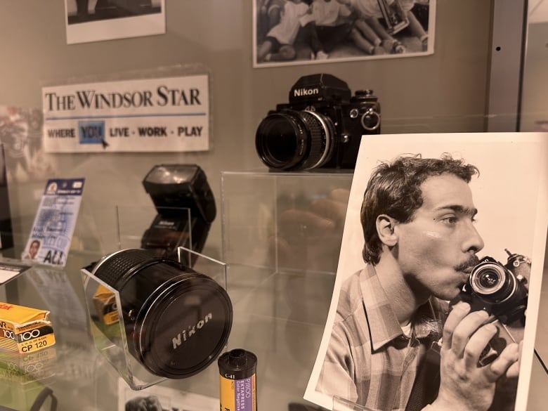 Photographer's memorabilia in a glass case.